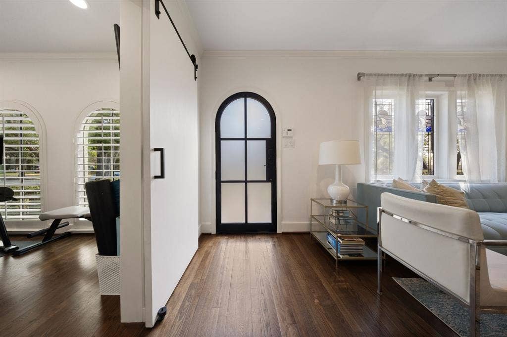 5709 Kenwood Avenue, Dallas, TX 75206 Rich wood-finish flooring throughout, complemented by a modern barn door