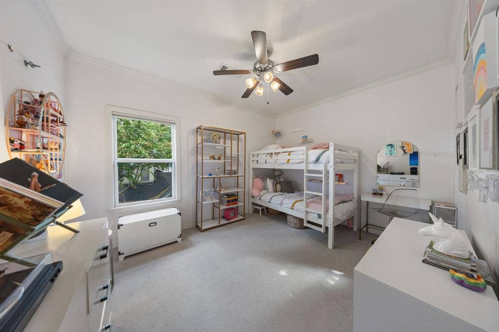 5709 Kenwood Avenue, Dallas, TX 75206 Vaulted ceiling featuring a ceiling fan, window with white trim, and light-toned carpet flooring