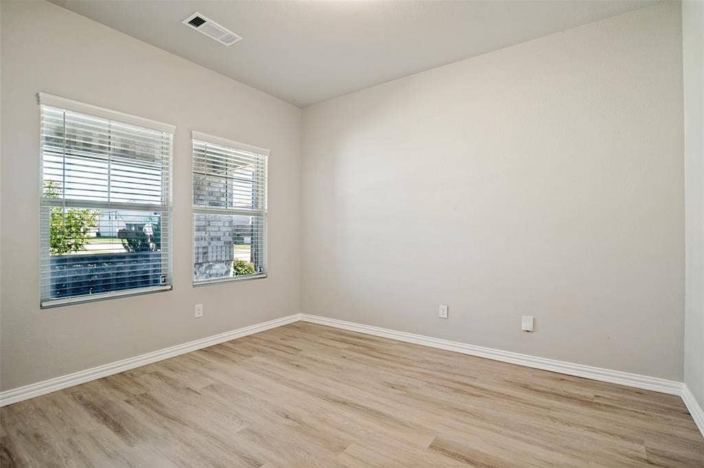 2403 Rocky Mountain Drive, Royse City, TX 75189 Recessed ceiling light, wood-finish flooring, two windows with blinds, and light-toned walls