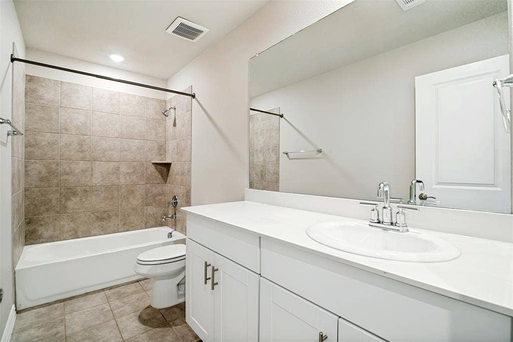 2403 Rocky Mountain Drive, Royse City, TX 75189 White vanity with brushed nickel hardware, integrated sink, and a large wall-mounted mirror