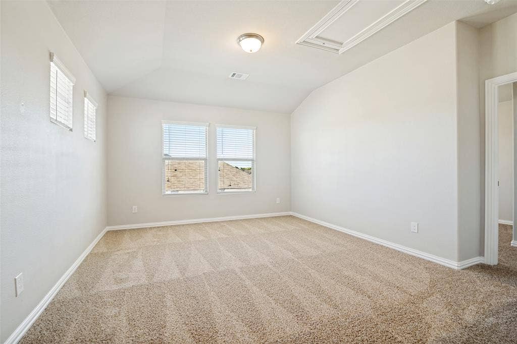 2403 Rocky Mountain Drive, Royse City, TX 75189 Neutral-toned carpeting with a textured pattern, vaulted ceiling, and recessed lighting