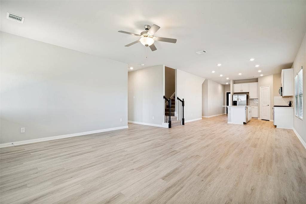 2403 Rocky Mountain Drive, Royse City, TX 75189 Open-concept living area with light wood-finish flooring, recessed lighting, and a ceiling fan