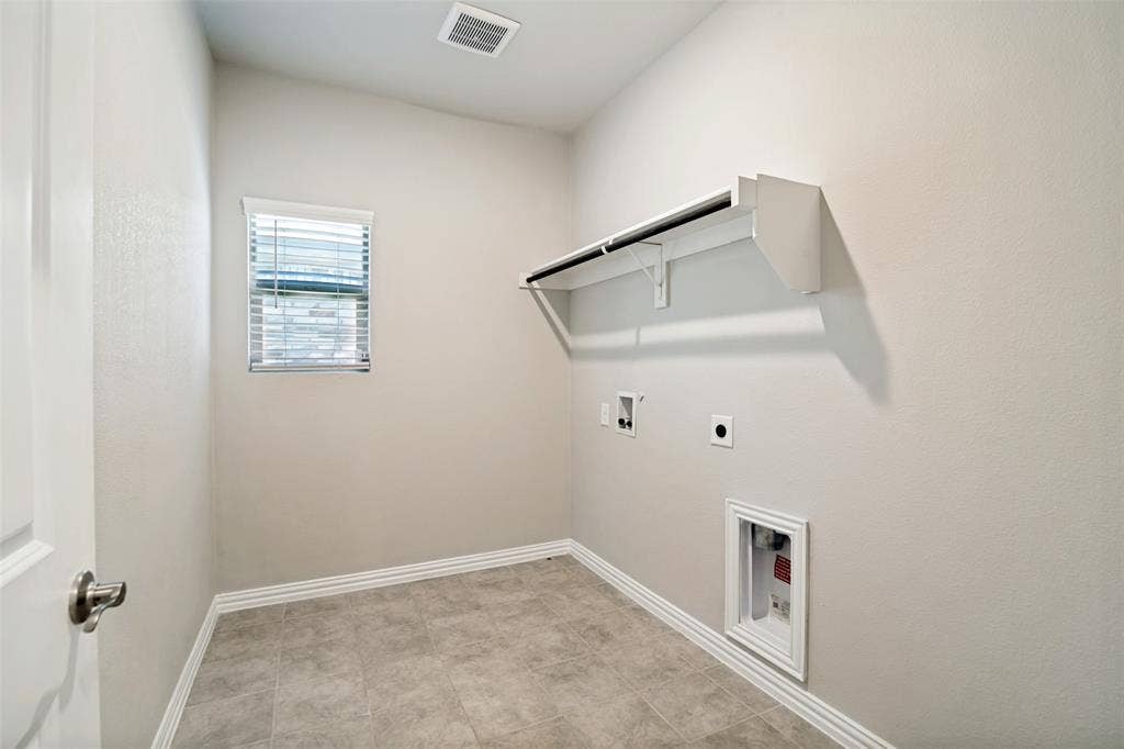 2403 Rocky Mountain Drive, Royse City, TX 75189 Built-in shelving with hanging rod, window with blinds, tile flooring, and utility hookups