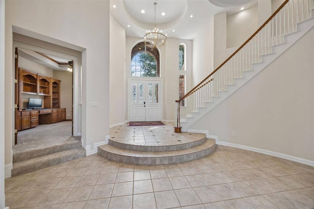 1106 Hills Creek Drive, McKinney, TX 75072 Looking back toward the entry, notice the curved lines of the entry and the striking light fixture. The study with handsome built-ins is just off the entry - perfect for work from home.