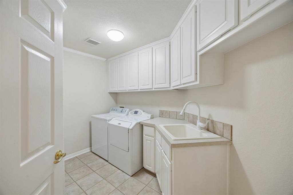 1106 Hills Creek Drive, McKinney, TX 75072 The spacious utility room has room for a second refrigerator as well as providing great storage, a utility sink and counterspace.