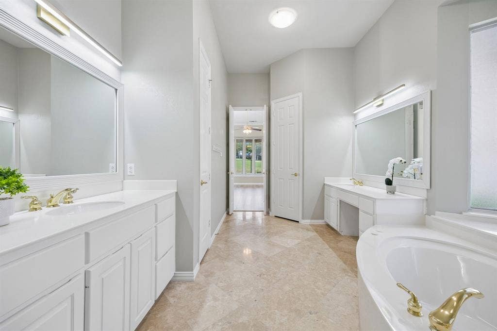 1106 Hills Creek Drive, McKinney, TX 75072 The primary bathroom offers nice storage including a small linen closet. The separate water closet is through the doorway shown on the right.