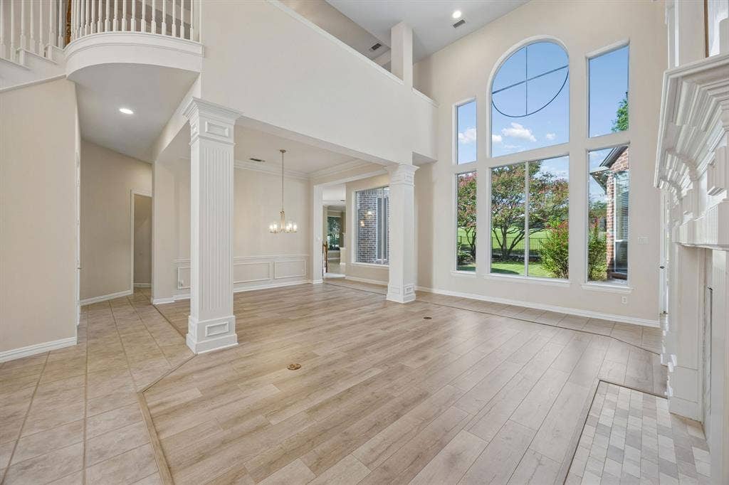 1106 Hills Creek Drive, McKinney, TX 75072 The space in the background is the formal dining room. The pillars provide a sense of separation. The opening to the left leads to the butler's pantry - so convenient when entertaining.