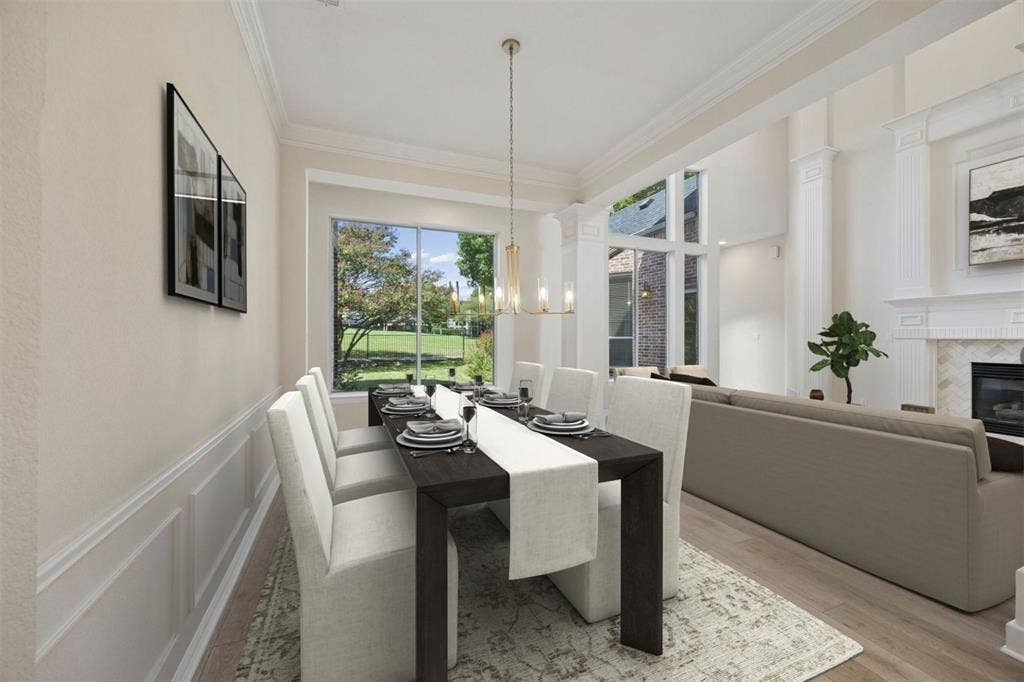 1106 Hills Creek Drive, McKinney, TX 75072 Features of the formal dining space include wainscotting, crown molding and stylish light fixture.
