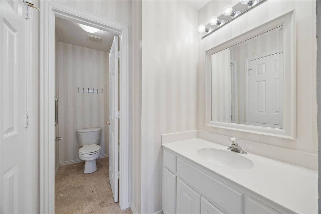 1106 Hills Creek Drive, McKinney, TX 75072 Vanity area of the jack and jill bathroom looking through to the shared watercloset with tub with shower.