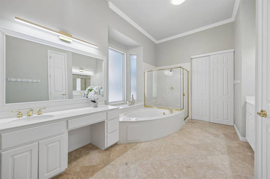 1106 Hills Creek Drive, McKinney, TX 75072 The en suite primary bath has dual vanities, framed mirrors, jetted tub and separate shower.