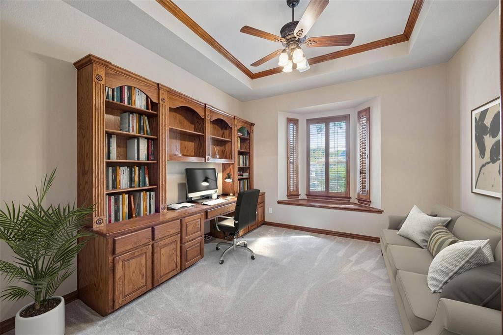 1106 Hills Creek Drive, McKinney, TX 75072 The study is found just off the entry and offers built-in desk with shelves and storage, tray ceiling with crown molding and ceiling fan, window seat with plantation shutters, carpet and a storage closet. (Virtually staged to show potential.)