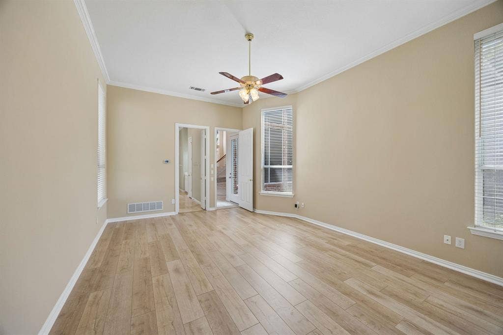 1106 Hills Creek Drive, McKinney, TX 75072 Features of the primary include en suite bath, large walk-in closet, ceiling fan, LVP flooring. Find backyard access through a doorway in the hall leading to the primary.