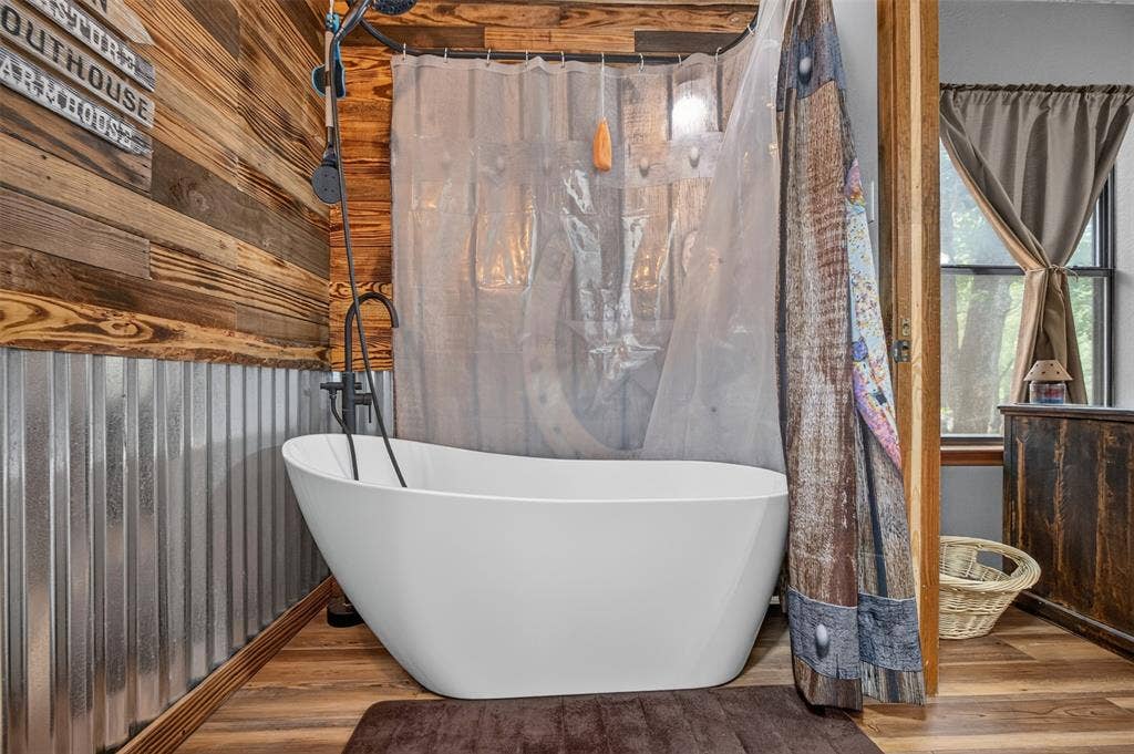 Freestanding soaking tub with a black bath filler