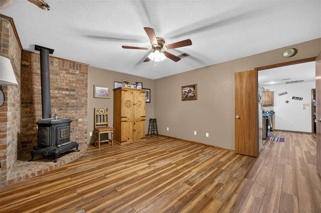Brick accent wall with a cast iron wood-burning stove