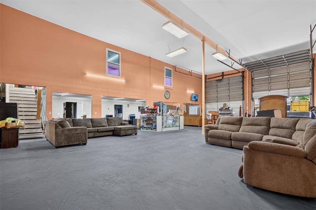 2301 S Denley Drive, Dallas, TX 75216 Spacious interior with high ceilings, multiple roll-up doors, and durable flooring
