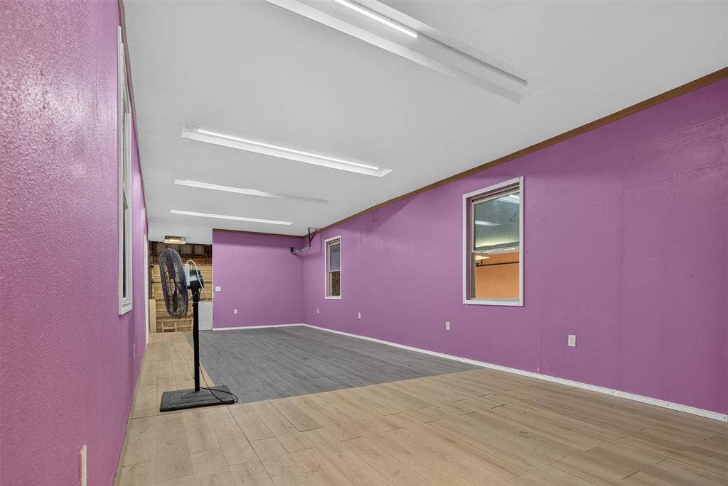 2301 S Denley Drive, Dallas, TX 75216 Recessed fluorescent lighting, dual-tone wood-finish flooring, multiple windows, and a neutral ceiling