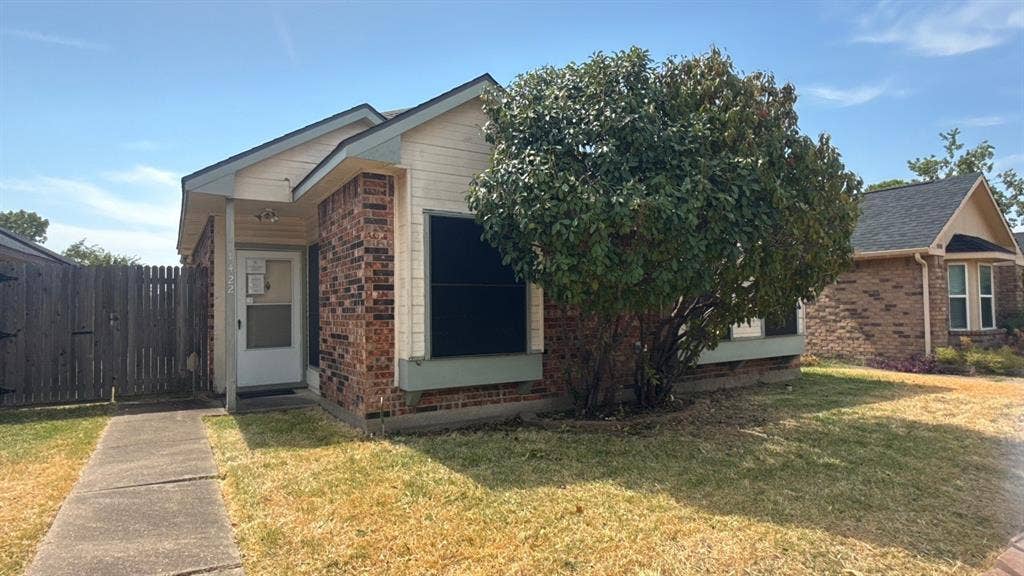 Brick exterior with light-colored siding accents and a contrasting dark roof