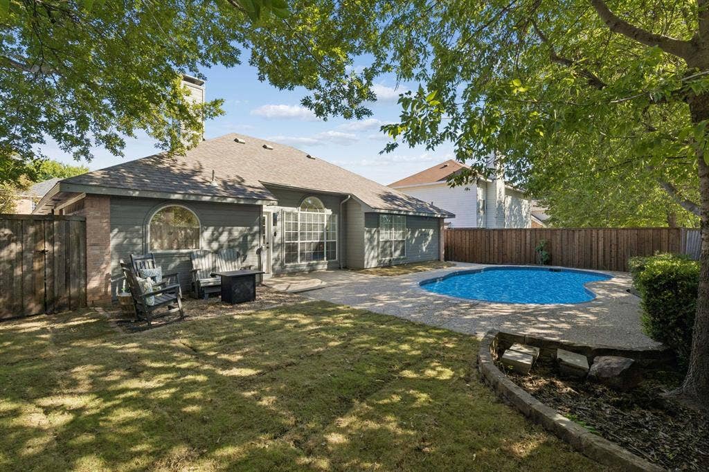 1111 Hyde Park Drive, McKinney, TX 75069 View of the backyard showing more of the grassy lawn.