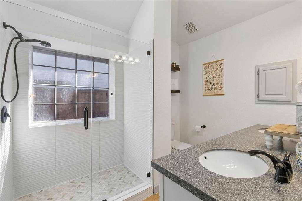 1111 Hyde Park Drive, McKinney, TX 75069 As you enter the the primary bathroom, you will see a large updated walk-in shower and LVP flooring.