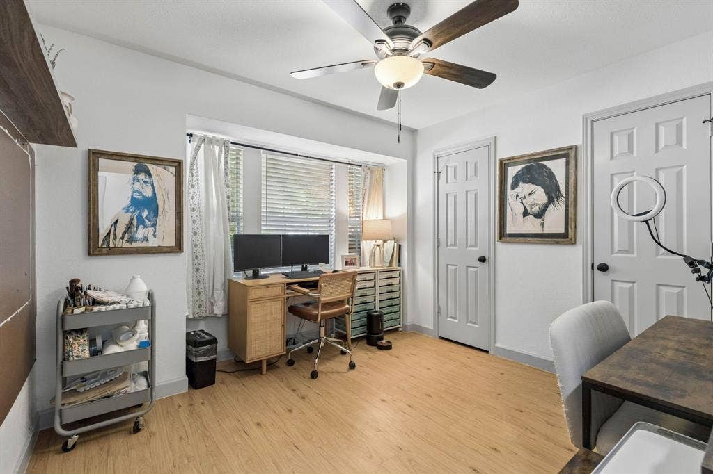 1111 Hyde Park Drive, McKinney, TX 75069 Another secondary bedroom being used as an office. This bedroom displays LVP flooring, a ceiling fan, large window and full wall length closet