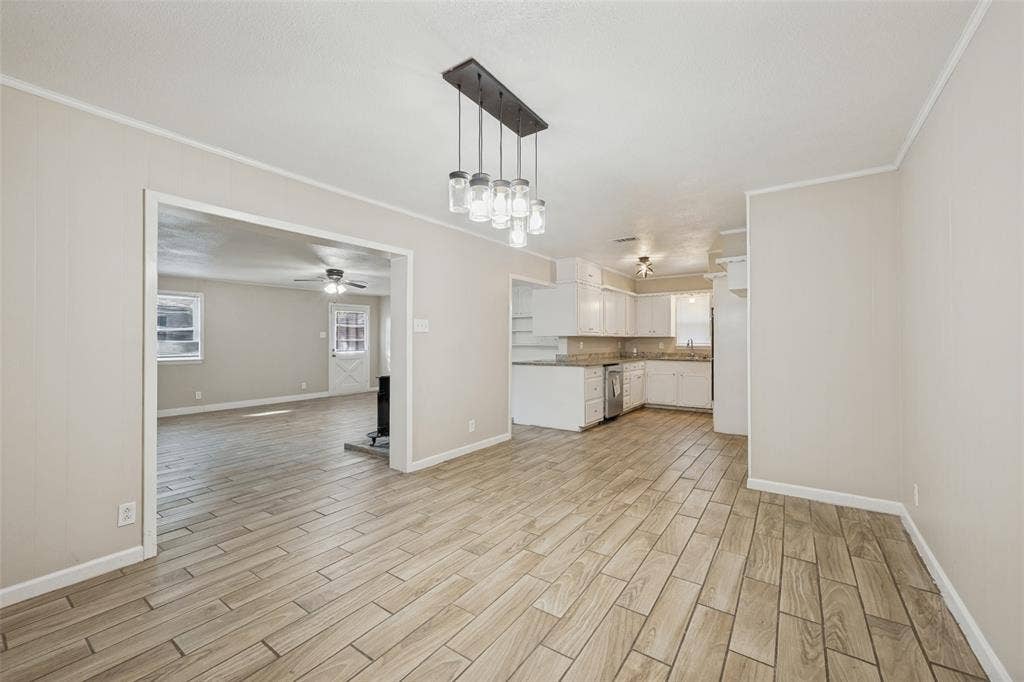 213 W Dorris Drive, Grand Prairie, TX 75051 Wood-finish tile flooring throughout, recessed lighting, modern chandelier, white cabinetry, and light-colored countertops
