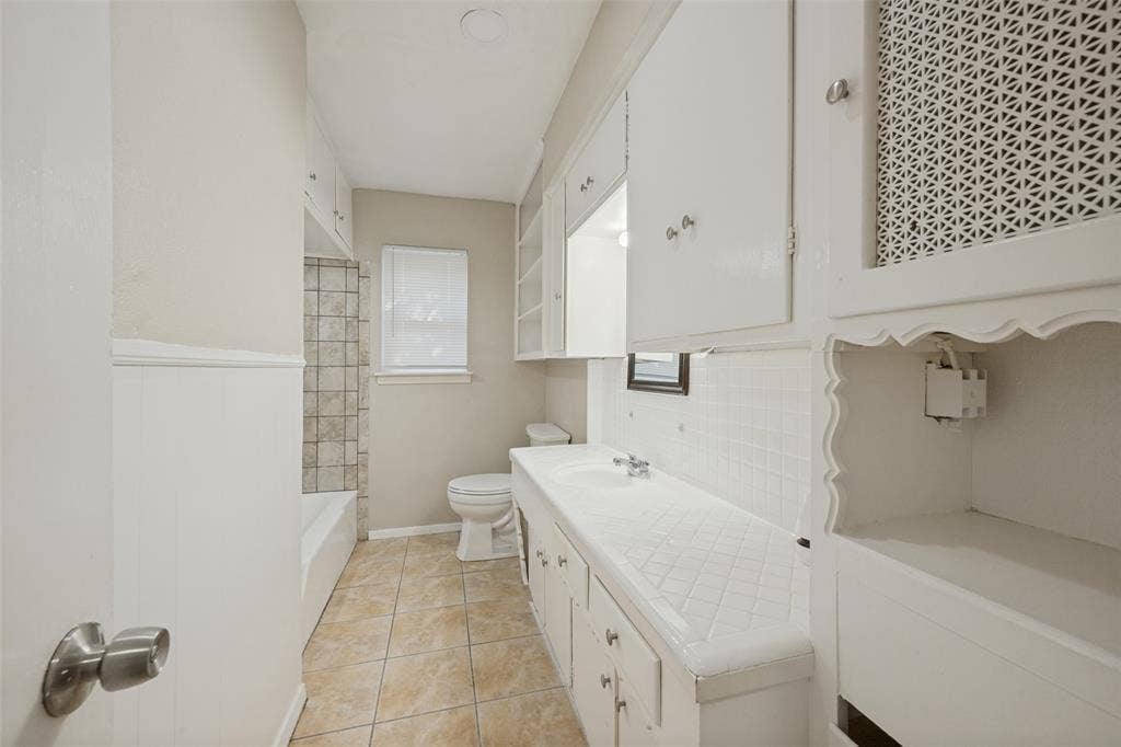 213 W Dorris Drive, Grand Prairie, TX 75051 Built-in shelving and cabinetry, tiled flooring, integrated sink, and white subway tile backsplash