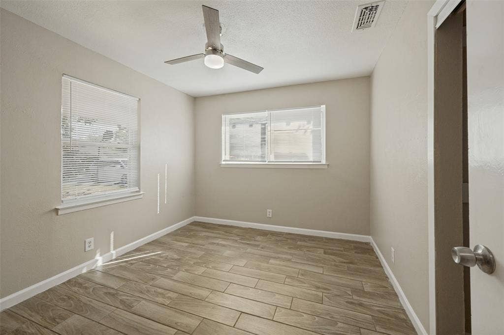 213 W Dorris Drive, Grand Prairie, TX 75051 Wood-finish flooring with neutral wall tones
