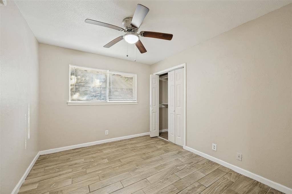 213 W Dorris Drive, Grand Prairie, TX 75051 Wood-finish tile flooring, ceiling fan with integrated lighting, and a window with blinds
