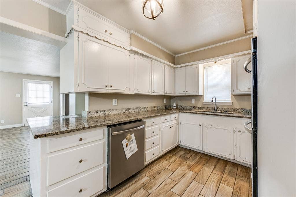 213 W Dorris Drive, Grand Prairie, TX 75051 Kitchen featuring white cabinetry, granite countertops, a stainless steel dishwasher, and wood-finish flooring