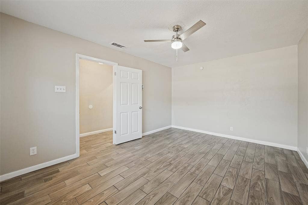 213 W Dorris Drive, Grand Prairie, TX 75051 Wood-finish tile flooring throughout, neutral paint palette, and a ceiling fan with integrated lighting