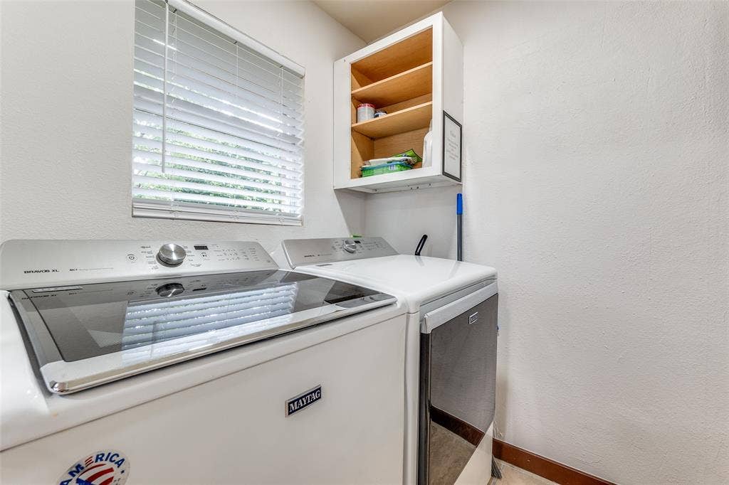 1816 Boyd Street, Dallas, TX 75224 Dedicated laundry area featuring a window with blinds and built-in upper cabinetry