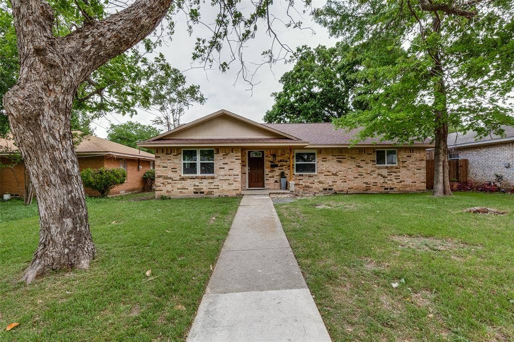 1816 Boyd Street, Dallas, TX 75224 Brick exterior with a gabled roof and a concrete pathway leading to the entry