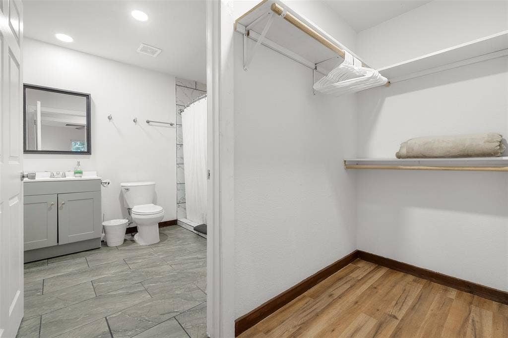 1816 Boyd Street, Dallas, TX 75224 ADU- Bathroom with gray tile flooring, a gray vanity with a white countertop, and a walk-in shower