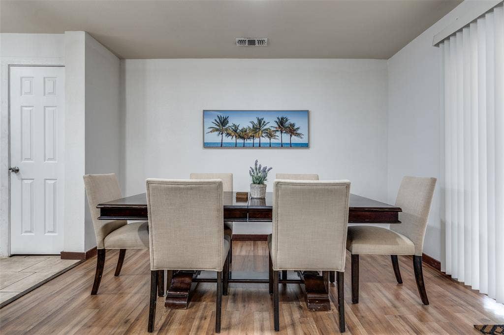 1816 Boyd Street, Dallas, TX 75224 Wood-finish flooring with white walls and a six-panel interior door