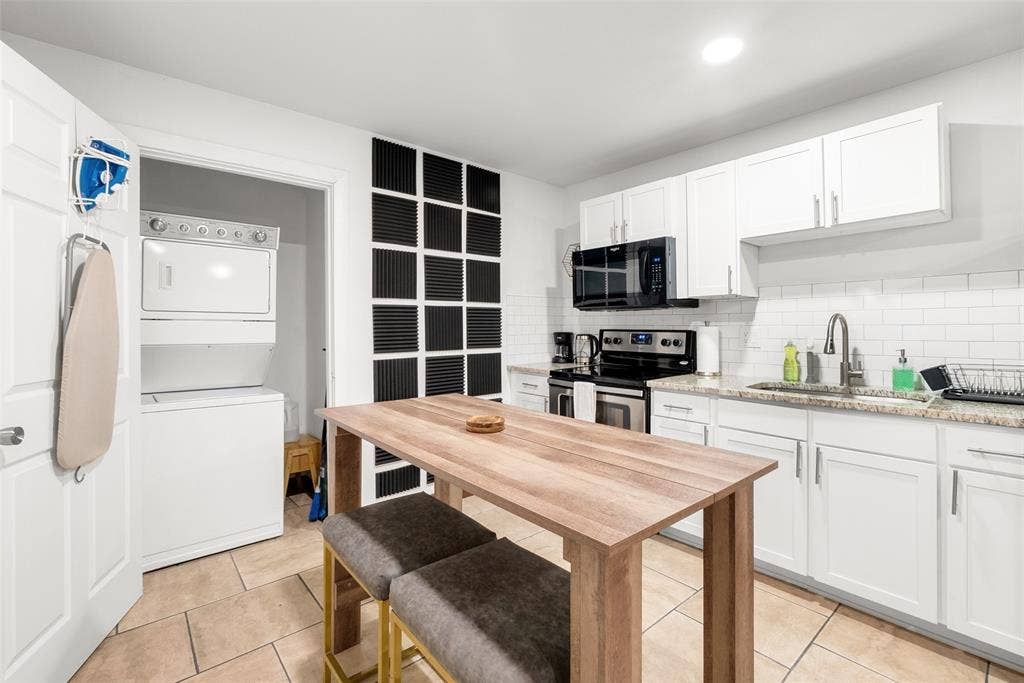 1816 Boyd Street, Dallas, TX 75224 ADU- White shaker cabinetry, subway tile backsplash, stainless steel appliances, and tile flooring