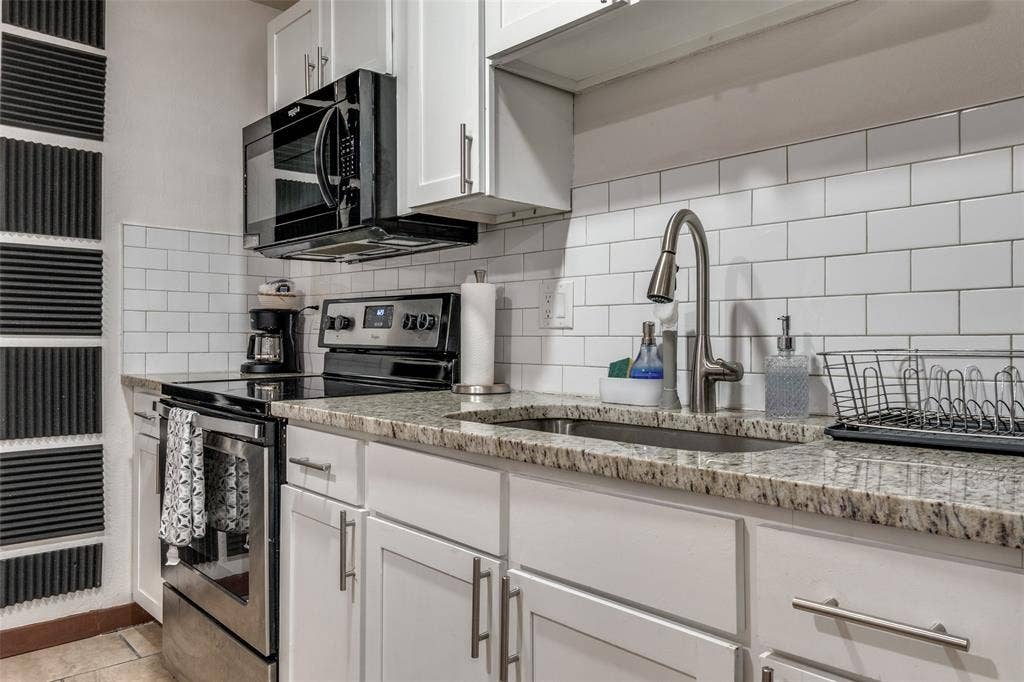 1816 Boyd Street, Dallas, TX 75224 ADU- Kitchen featuring white shaker-style cabinetry, granite-style countertops, stainless steel appliances, a subway tile backsplash, and a stainless steel sink with a gooseneck faucet