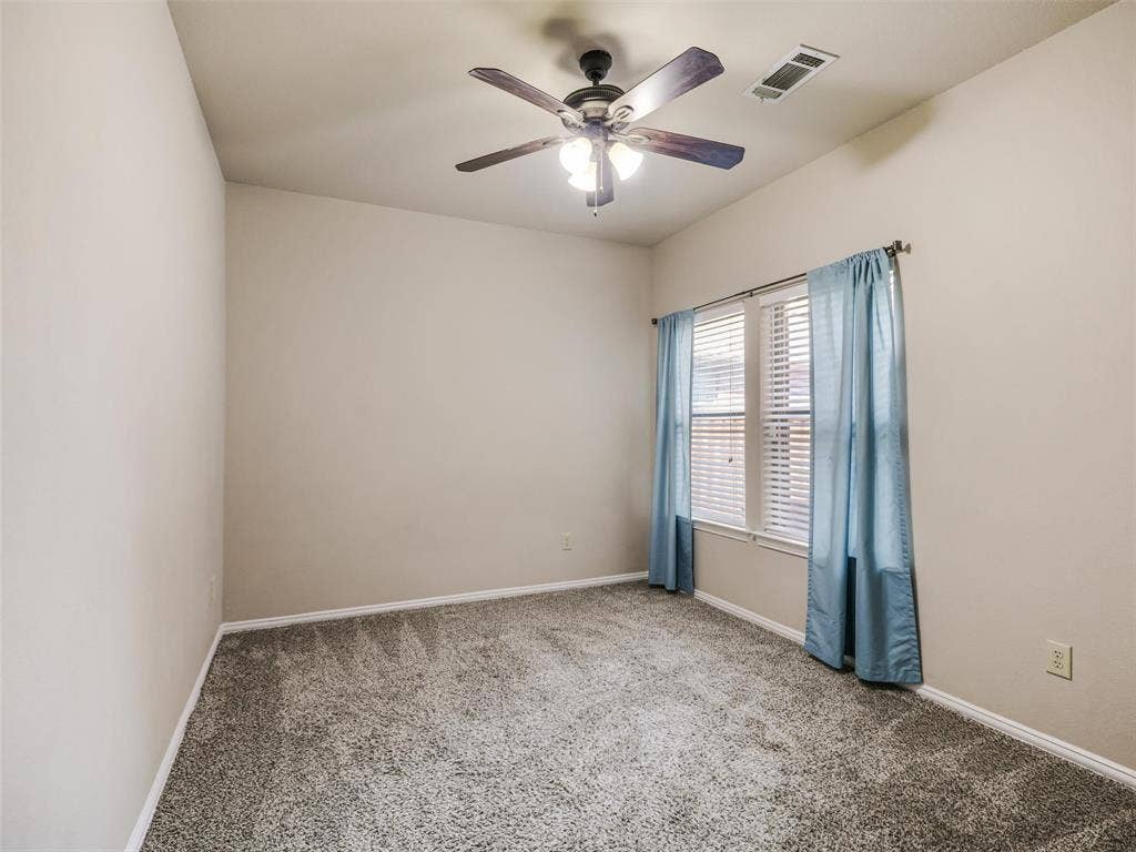 8374 Cain River Drive, Frisco, TX 75035 Versatile secondary bedroom with neutral finishes, carpeting, and a ceiling fan offers space for guests, work, or hobbies.