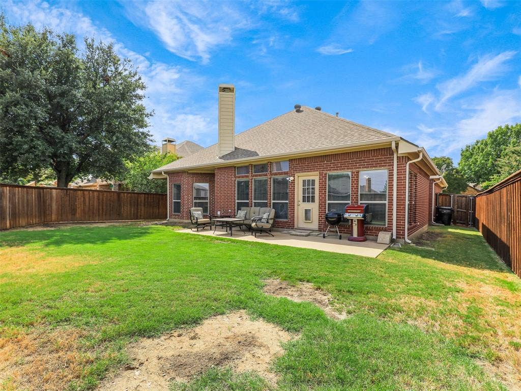 8374 Cain River Drive, Frisco, TX 75035 Enjoy outdoor gatherings on the backyard patio, with direct access to the home and an open lawn enclosed by wood fencing.