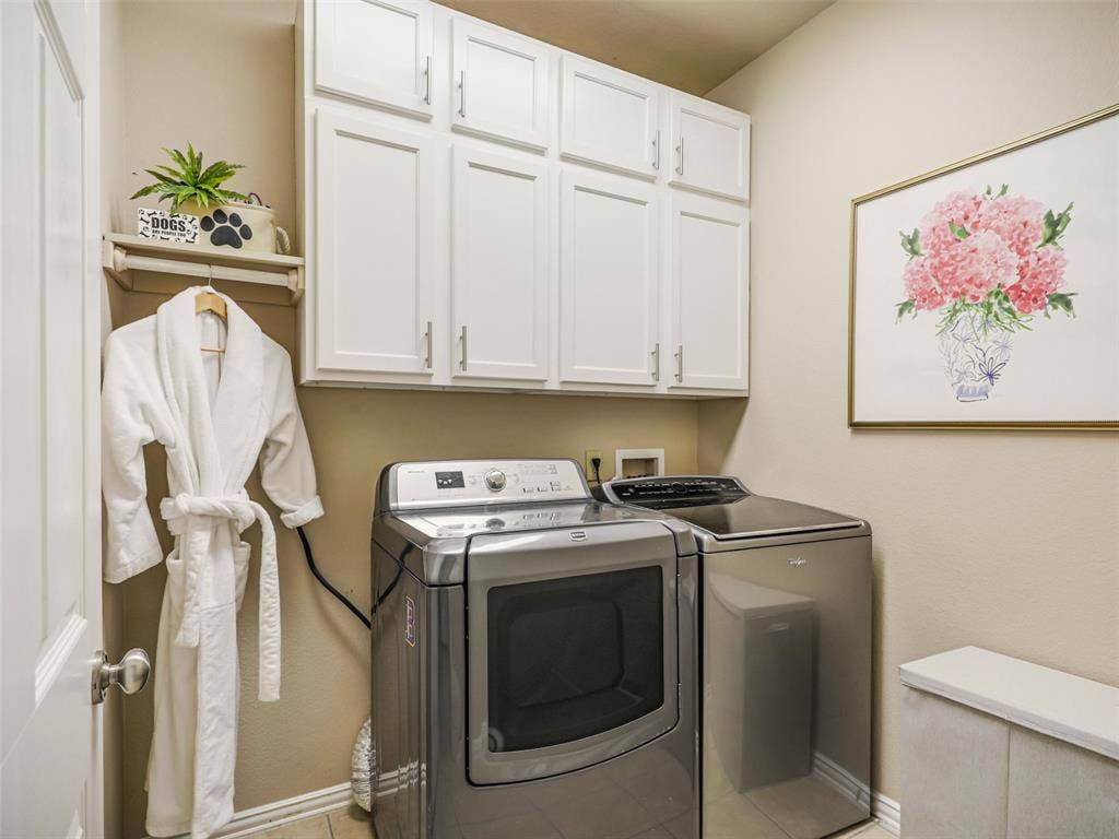 8374 Cain River Drive, Frisco, TX 75035 Dedicated laundry room features overhead cabinetry and a hanging rod for convenient storage and organization.