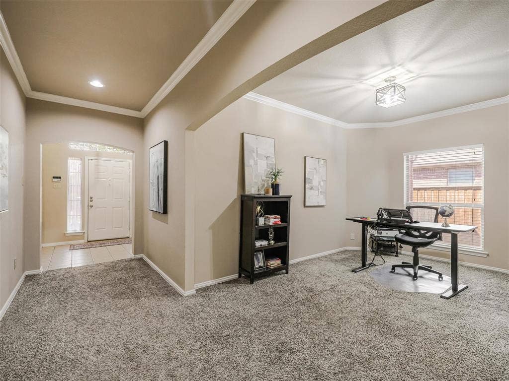 8374 Cain River Drive, Frisco, TX 75035 Versatile front room, currently used as a home office, features crown molding, natural light, and a wide opening to the entry hallway.