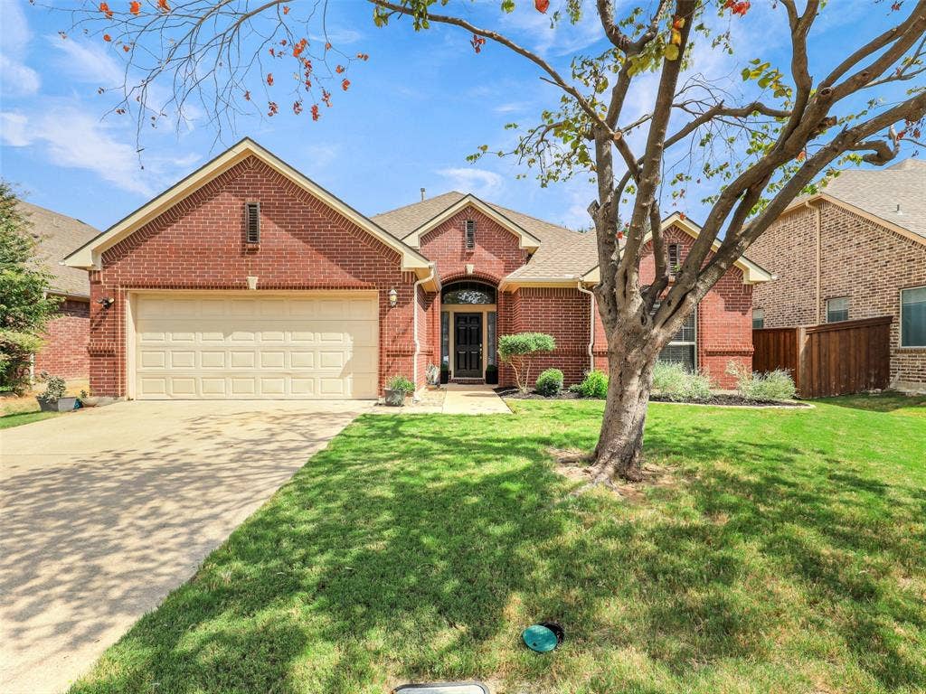 8374 Cain River Drive, Frisco, TX 75035 Inviting single-story brick home with a two-car garage, landscaped front yard, and a mature shade tree.