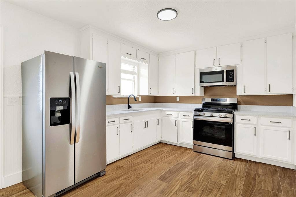 306 Hilltop Avenue, #A, Richardson, TX 75081 Gas Stovetop..Updated Kitchen with white cabinets, light hardwood / wood-style floors, and appliances with stainless steel finishes