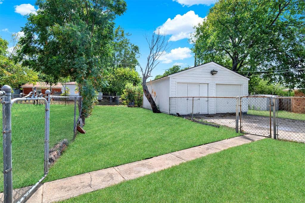 306 Hilltop Avenue, #A, Richardson, TX 75081 View of yard with an outdoor structure and a garage