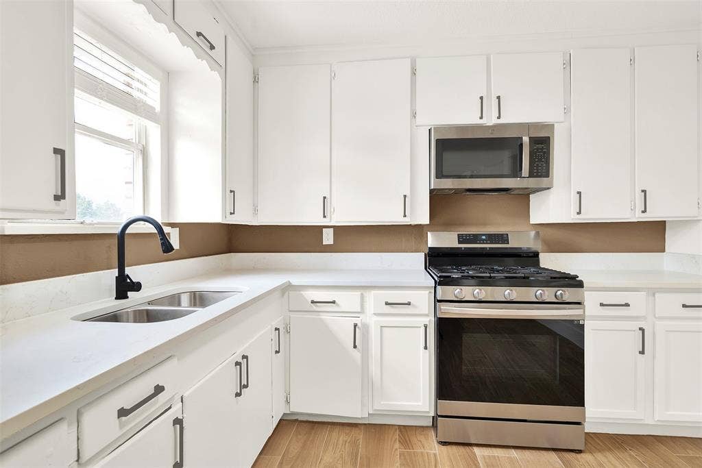 306 Hilltop Avenue, #A, Richardson, TX 75081 Kitchen featuring light hardwood / wood-style flooring, stainless steel appliances, sink, and white cabinetry