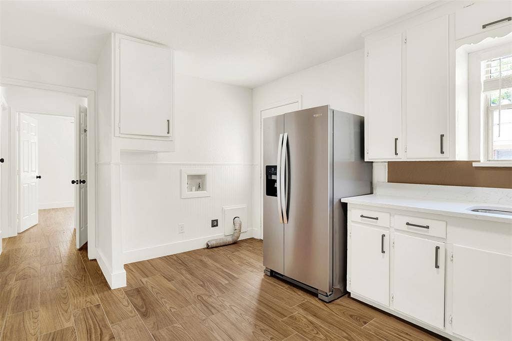 306 Hilltop Avenue, #A, Richardson, TX 75081 Kitchen featuring light wood-type flooring, stainless steel fridge, and white cabinets