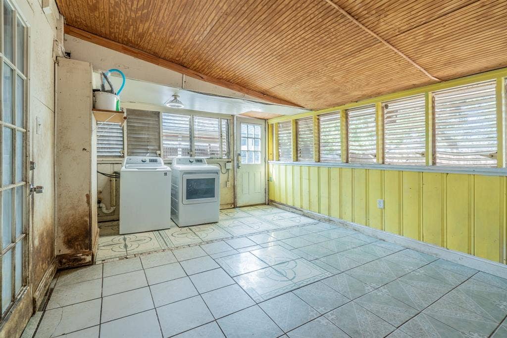 934 Indian Hills Drive, Grand Prairie, TX 75051 Tile flooring, wood-paneled ceiling, multiple window openings, and a utility sink