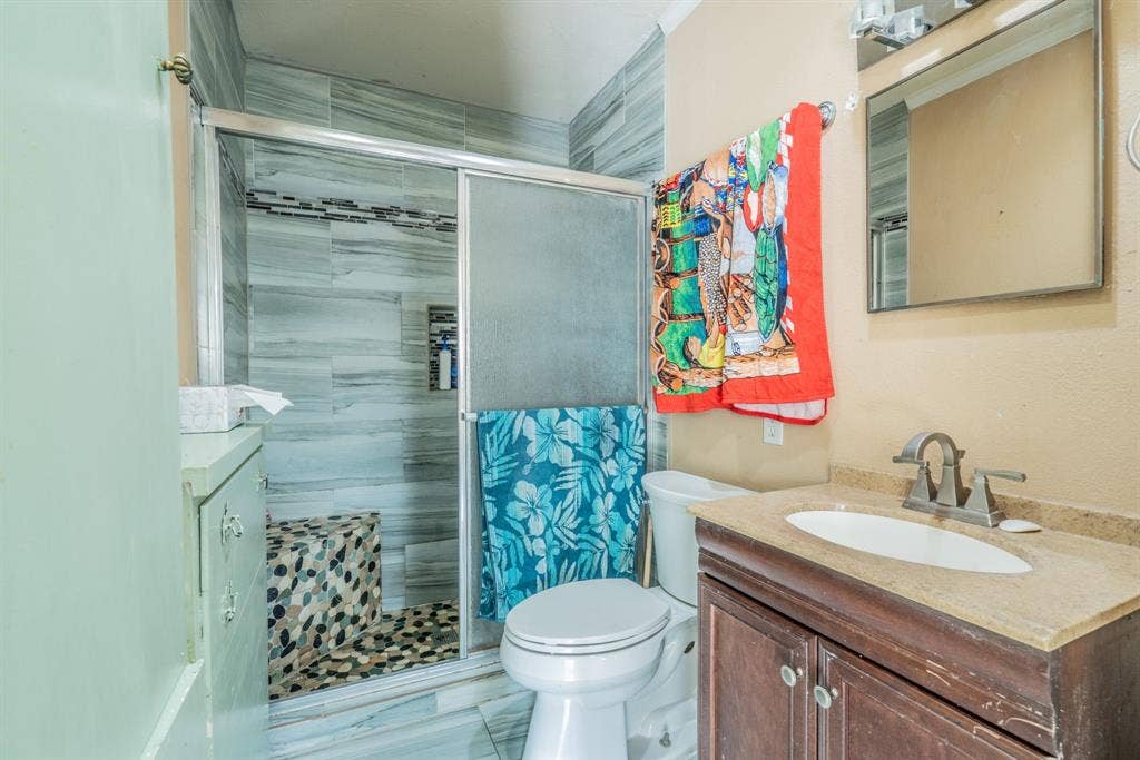 934 Indian Hills Drive, Grand Prairie, TX 75051 Walk-in shower with tile surround and built-in bench