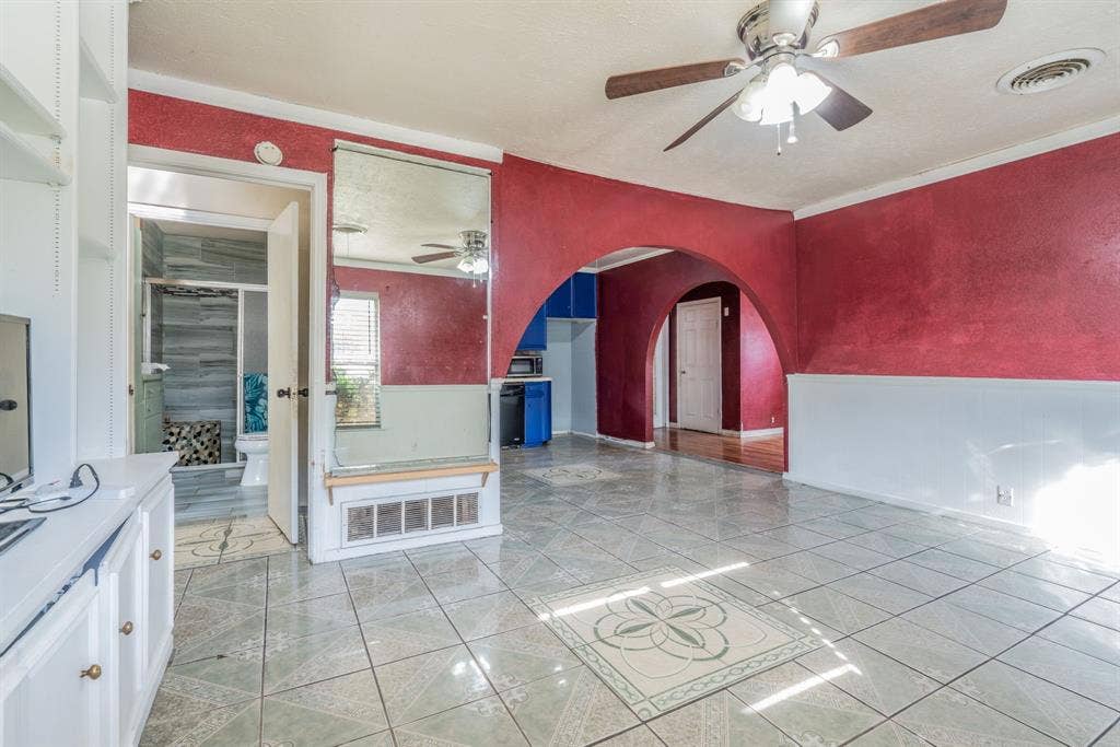 934 Indian Hills Drive, Grand Prairie, TX 75051 Tile flooring with an integrated decorative pattern, a ceiling fan, and arched doorways
