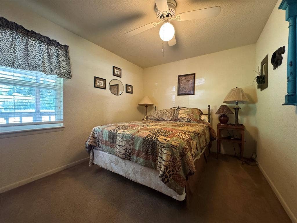 10122 Ash Cove, Wills Point, TX 75169 Wall-to-wall carpeted flooring, window with blinds, and ceiling fan with integrated lighting