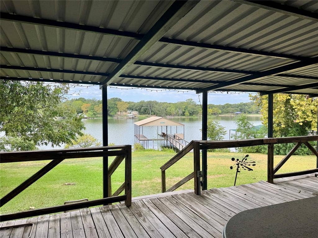 10122 Ash Cove, Wills Point, TX 75169 Expansive wooden deck with an overhead metal roof structure